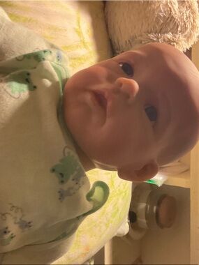 Reborn Doll in Cream Outfit with Light Green Frog Accents